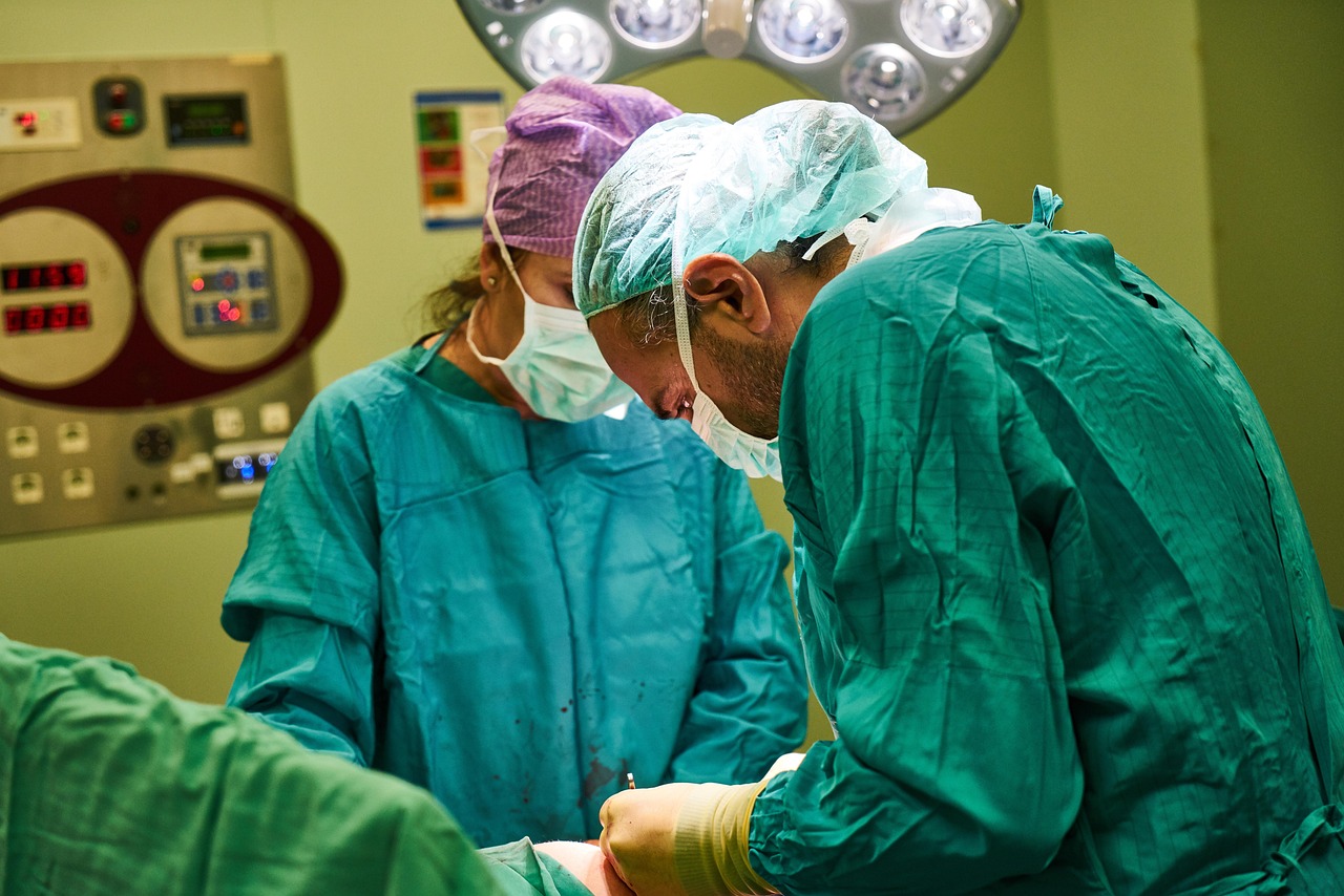 Surgeons in green scrubs during an operation