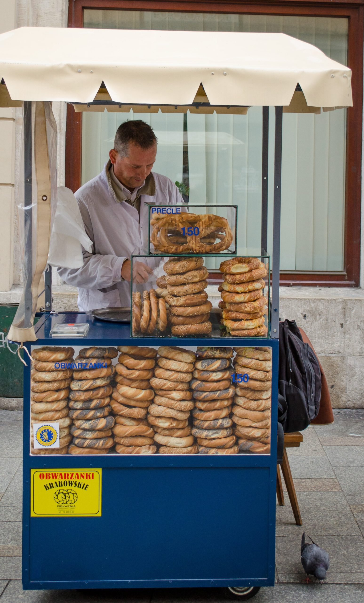 An obwarzanek seller's cart in Kraków with bread rings stacked on sticks